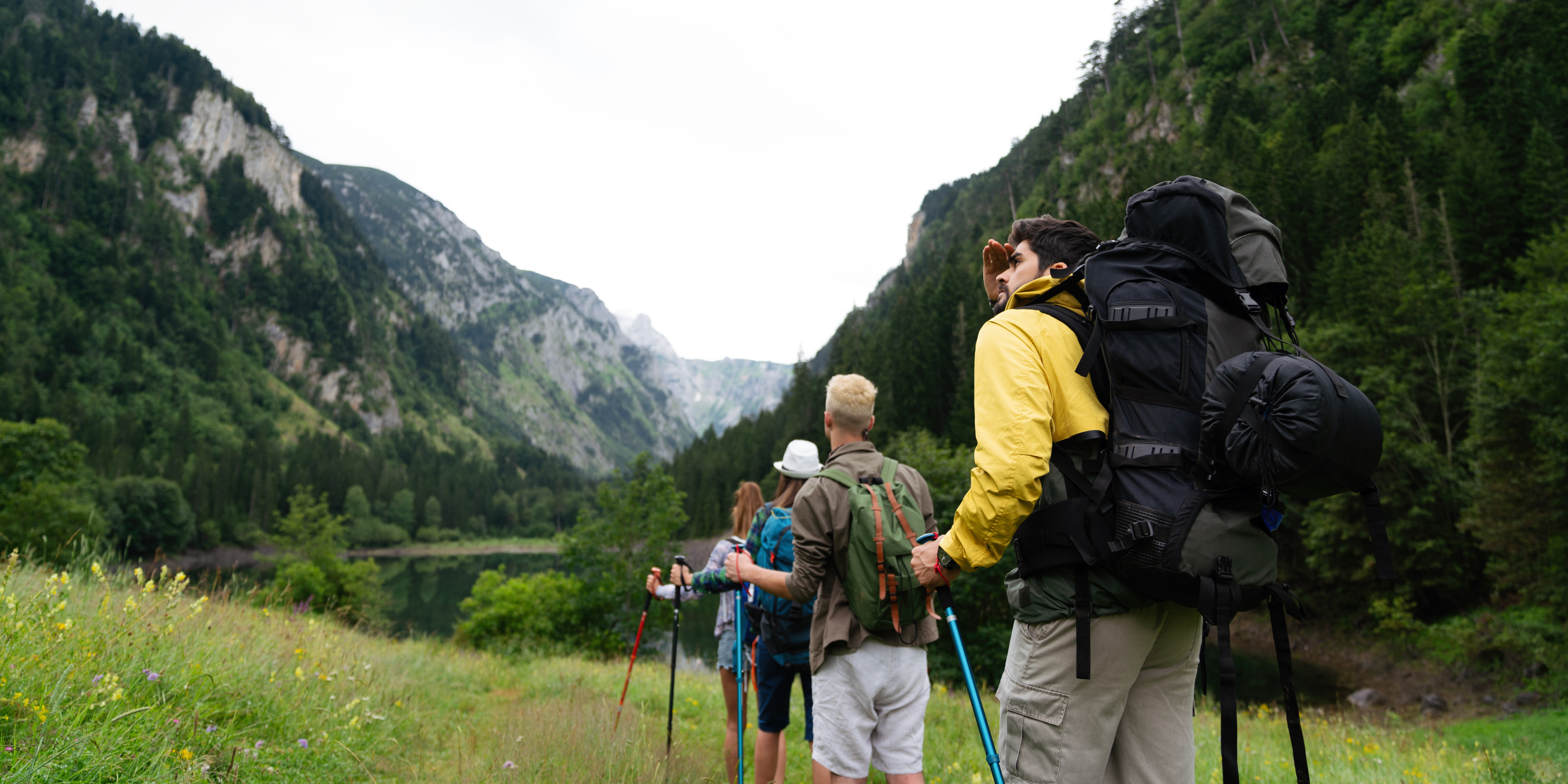 Hikers with backpacks in a mountainous landscape